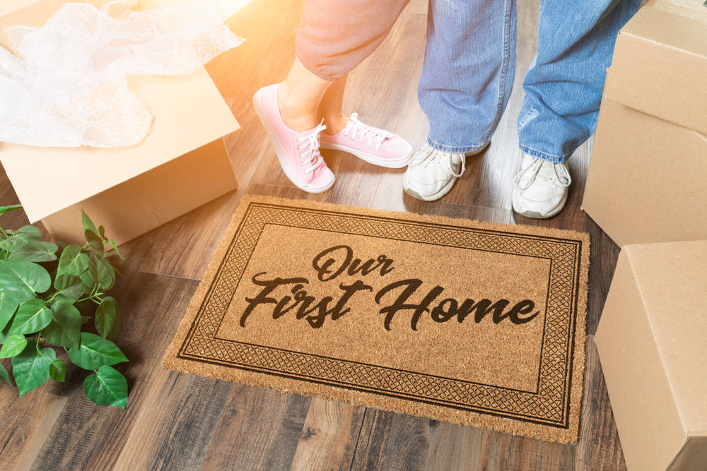 Man,And,Woman,Unpacking,Near,Our,First,Home,Welcome,Mat,